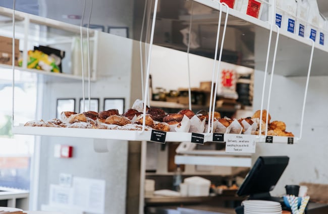 Pastries and muffins on a high shelf at Ilex Café, Christchurch.