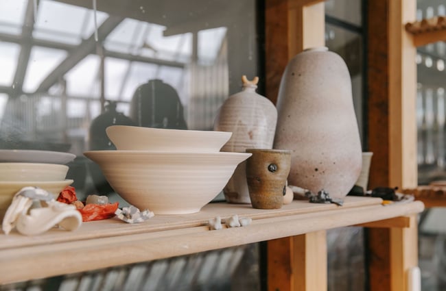 Unfired pottery on a shelf at Kiln Studio.