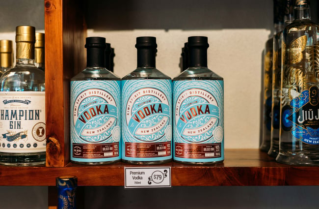 Bottles of vodka lined up on a shelf.