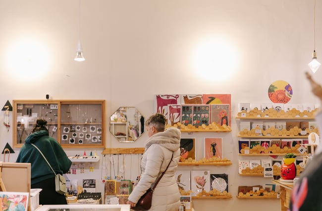 Two woman browsing at Little Beehive Co-op.