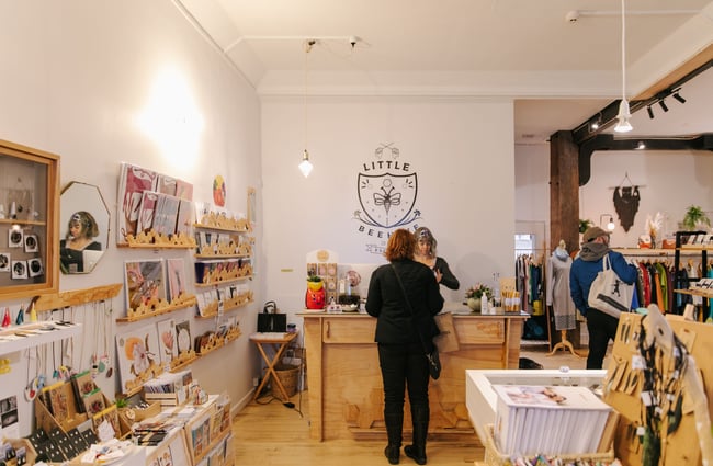 Woman paying at the counter at Little Beehive Co-op.