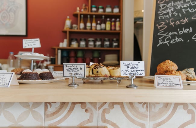 The counter at Little Dove cafe covered in cabinet foods on nice plates.