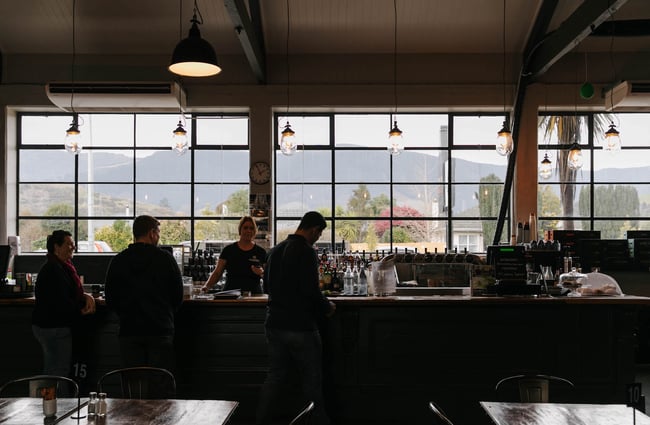 Customers standing at the bar McCashins Brewery.