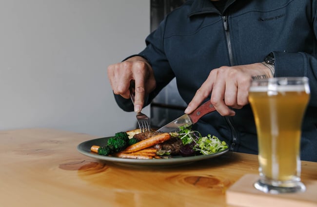 Man eating a meal at McCashins Brewery.