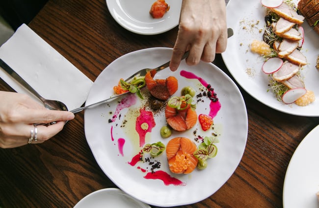 Someone eating salmon dish at Mona Vale in Christchurch.