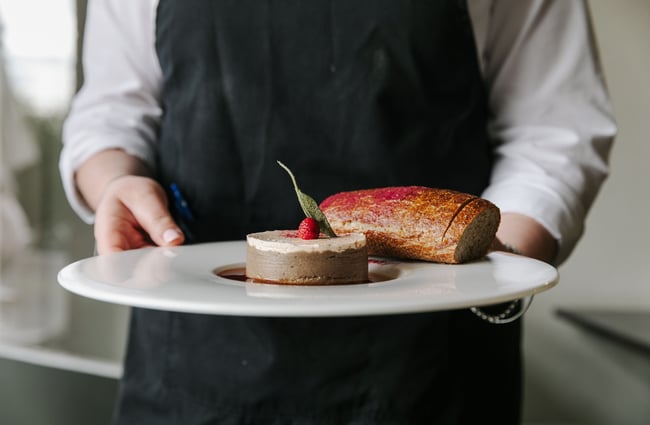 Waiter holding mushroom fois gras at Mona Vale in Christchurch.