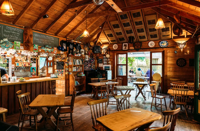 Wooden tables and chairs inside the dining room at Mussel Inn.