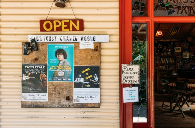 Gig posters on a board by the entrance to Mussel Inn.