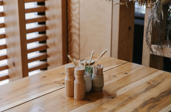 Salt and pepper and dried flowers in a vase on table at Old Factory Corner, Nelson Tasman.