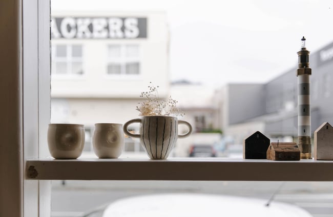 Cups in the window of Red Gallery and Cafe.