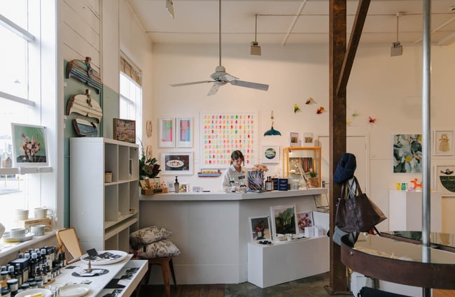 Woman working behind the counter at Red Gallery and Cafe.