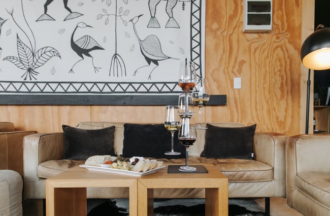 Wine glasses and a cheese platter on a table.