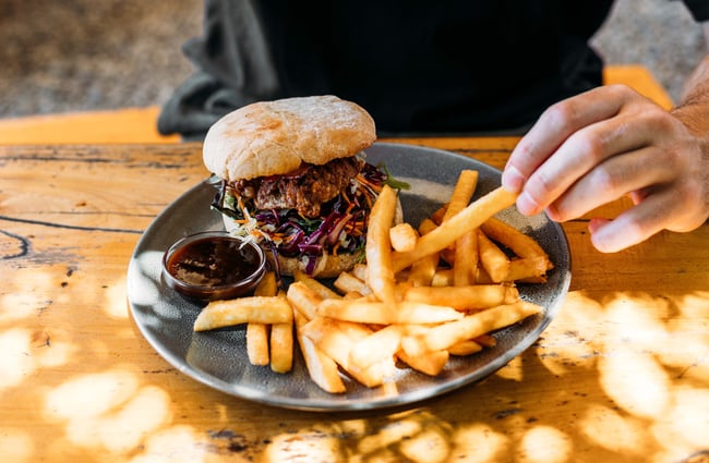 A close up of burgers and chips.