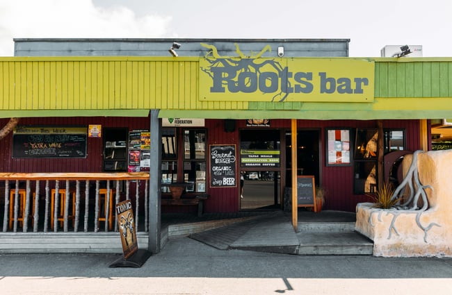 The green and red painted exterior of Roots Bar.