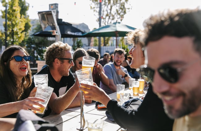 Friends saying cheers at a table.