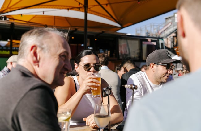 Woman sipping on a pint of beer.