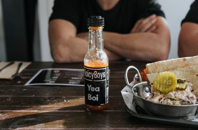 Close up of hot sauce on a table.