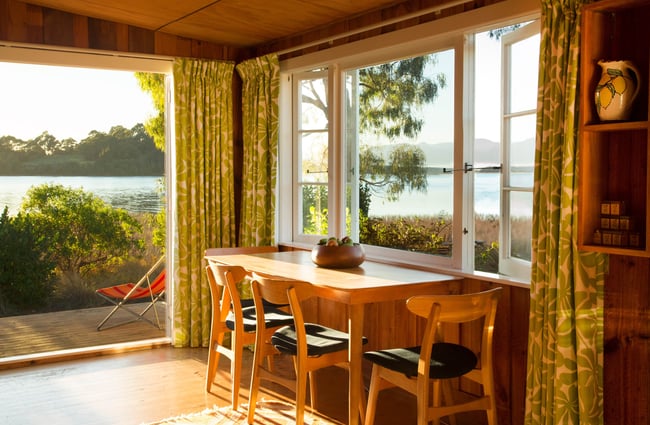 A view of the water from a small dining table.