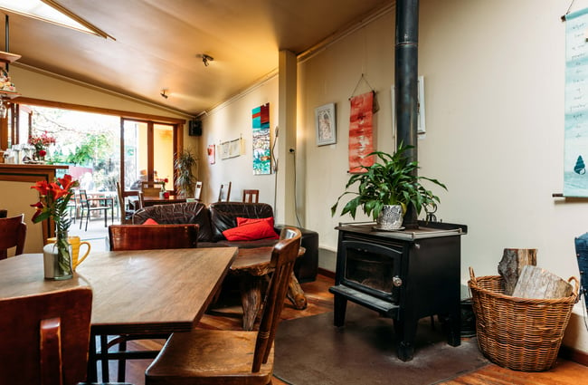 Seating and a couch next to a fireplace.