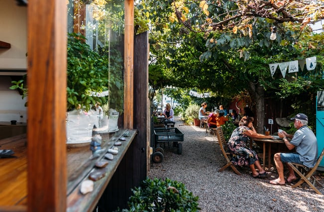 Customers sitting at tables outside the cafe.