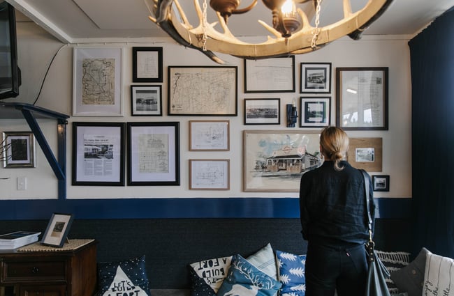 Woman looking at pictures on the wall at Fort Enfield in Waitaki.