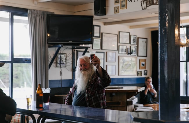 Local patron raising a drink at The Fort Enfield in Waitaki.