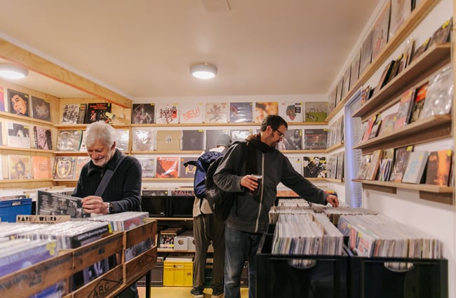 People shopping record collection at The Free House.