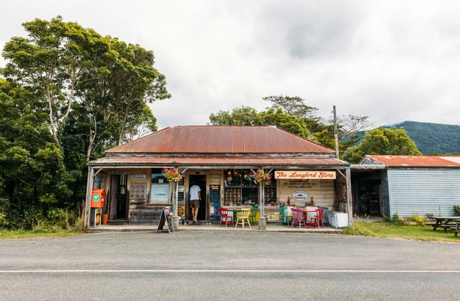 An old looking building with products positioned out front.