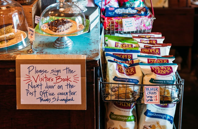 Bags of crisps on display on a counter.