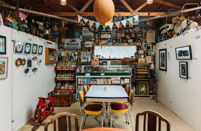 A formica table and chairs at the back of a makeshift cafe space.