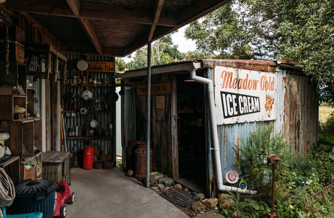 An old shack with gardening equipment.