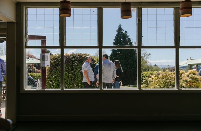 Looking through window to people standing outside at The Moutere Inn, Nelson Tasman.