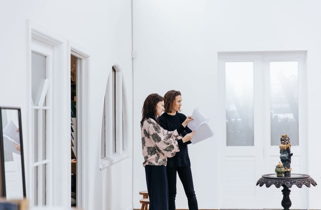 Interior of the gallery space with two women.