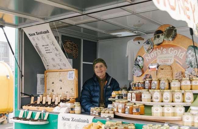 Man selling honey at The Nelson Market, Nelson.