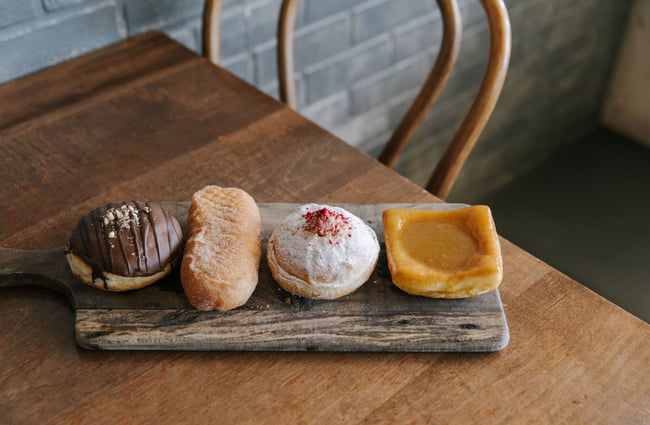 Selection of donuts on wooden board at The Smoking Barrel, Motueka Tasman.