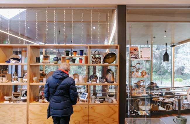 Woman browsing the gift shop at The Suter Art Gallery.