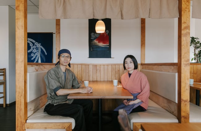 The owners of Tomi's sitting in one of the booths.