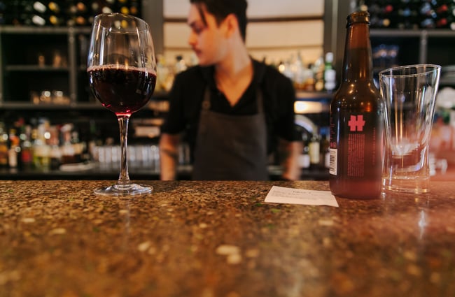 Glass of red wine on the bar.