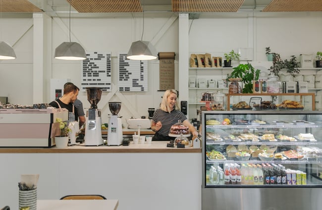 Workers in their navy and white stripped tops working behind the counter.