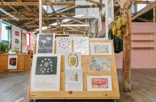 Artwork in wooden display shelving at Zappekin Artists & Allies, Nelson Tasman.