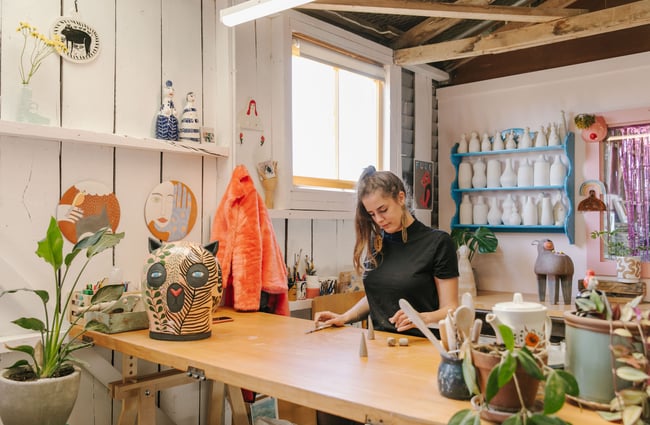 Woman creating art at work bench at Zappekin Artists & Allies, Nelson Tasman.