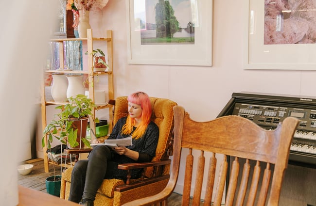 Woman working on orange chair at Zappekin Artists & Allies, Nelson Tasman.