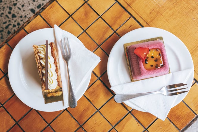Two tarts, plated, on a counter at Vaniyé Pâtisserie.