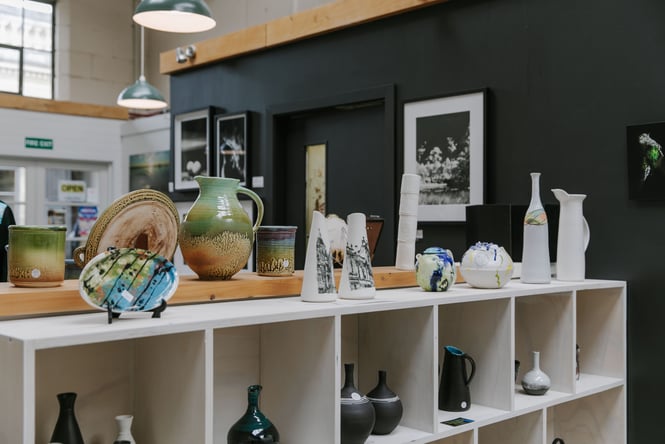 The top of shelves covered in ceramics at CRAFTED in Waitaki.