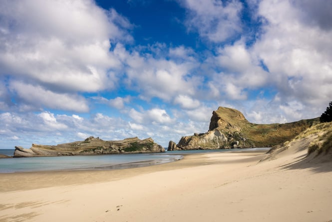 A beach on a sunny day at Castlepoint in New Zealand.