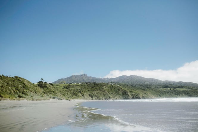 Raglan beach with mountain views in the background