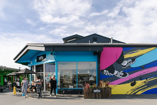 The blue and graffiti painted exterior of Switch New Brighton.