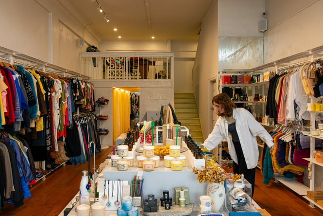 Woman browsing selection of gifts at clothing and homeware store