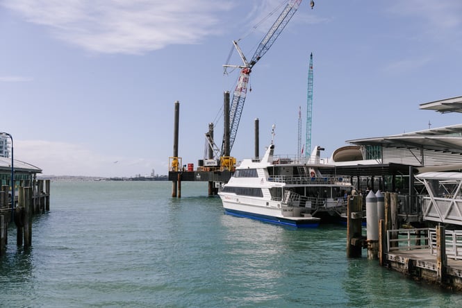 A boat on the water at the Auckland Viaduct.