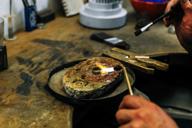 A jeweller adding the final touches to a handmade ring with a blowtorch